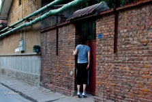 My Chinese friend, less inhibited than I, peers into one of the courtyards.