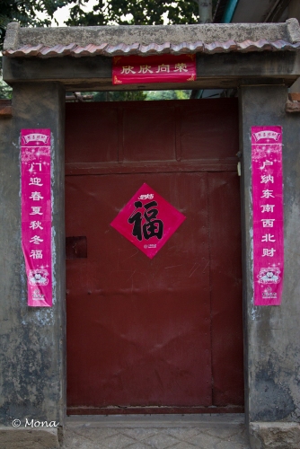 As I understand it, the paper picture and banners call for good fortune, good health, and happiness. They are hung during the Chinese New Year and remain throughout the year as talismans to bring good fortune into the household.